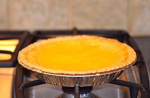 A close up of a buttermilk pie on top of the stove