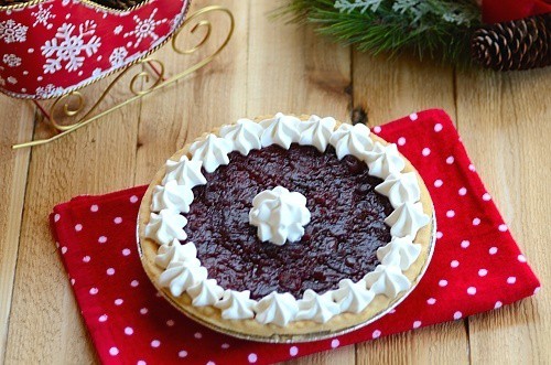 Orange Buttermilk Pie decorated with dollops of whipped chream