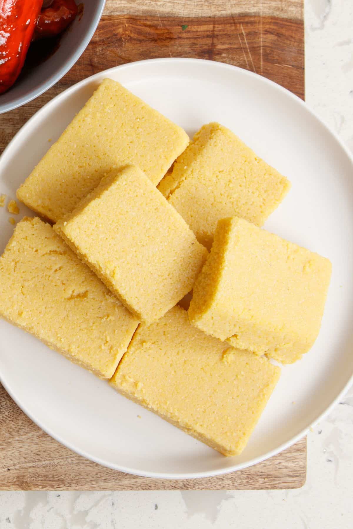 Chilled polenta pieces in a plate.