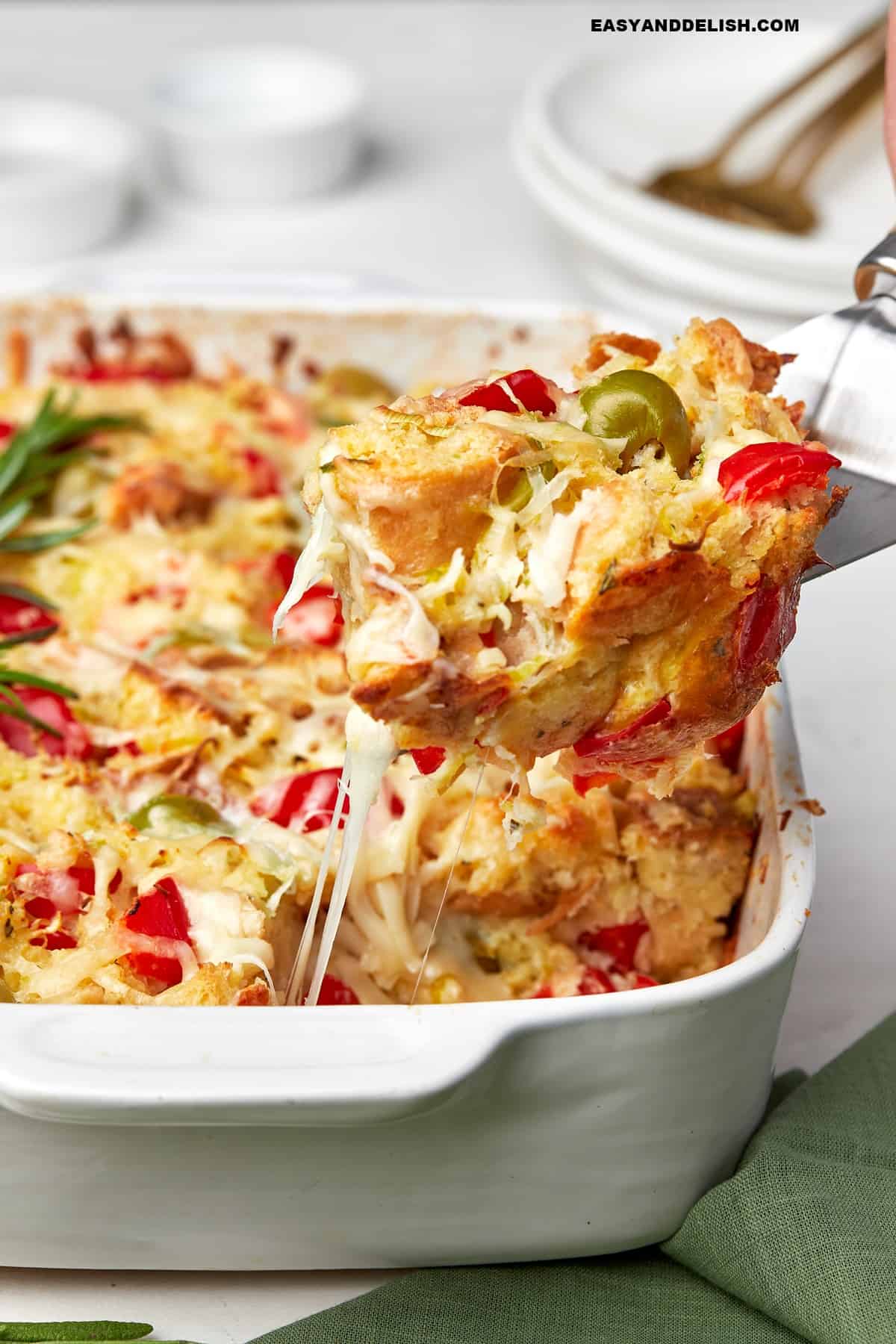 a slice of breakfast strata lifted with a metal spatula.