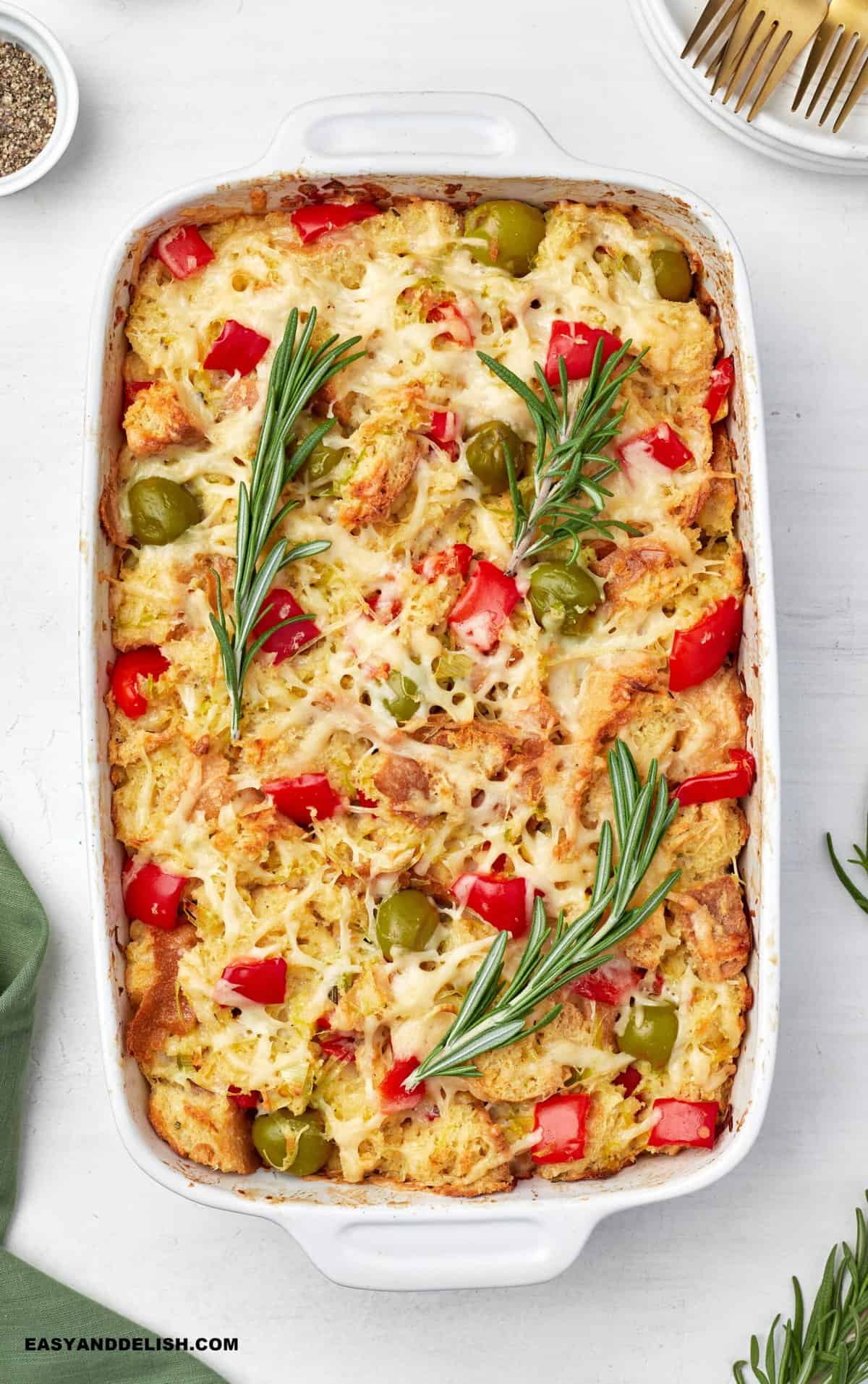 vegetarian savory bread pudding with garnishes on top and around.