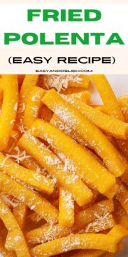 Close up of a bunch of polenta fries topped with Parmesan cheese.