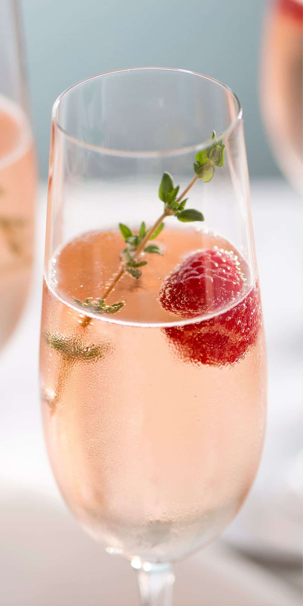 Vodka champagne cocktail in a flute glass as one of our New Year's Eve Cocktails.