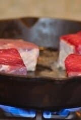 slices of beef in a skillet