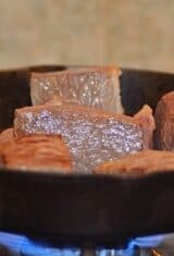 slices of beef browning in a skillet