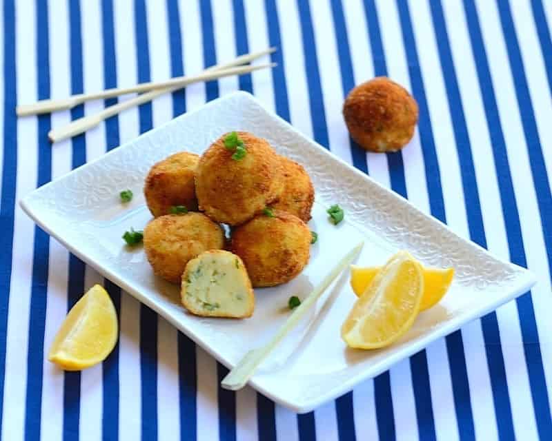 A plate of cod cakes with garnishes