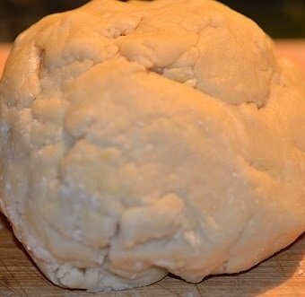 a ball of empanada dough on a board