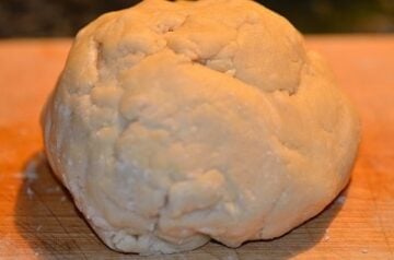 a ball of empanada dough on a board