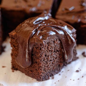 a slice of dairy-free chocolate cake topped with chocolate sauce