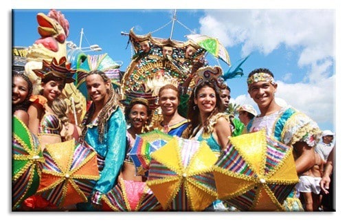 A group of people posing for the camera with carnival umbrellas