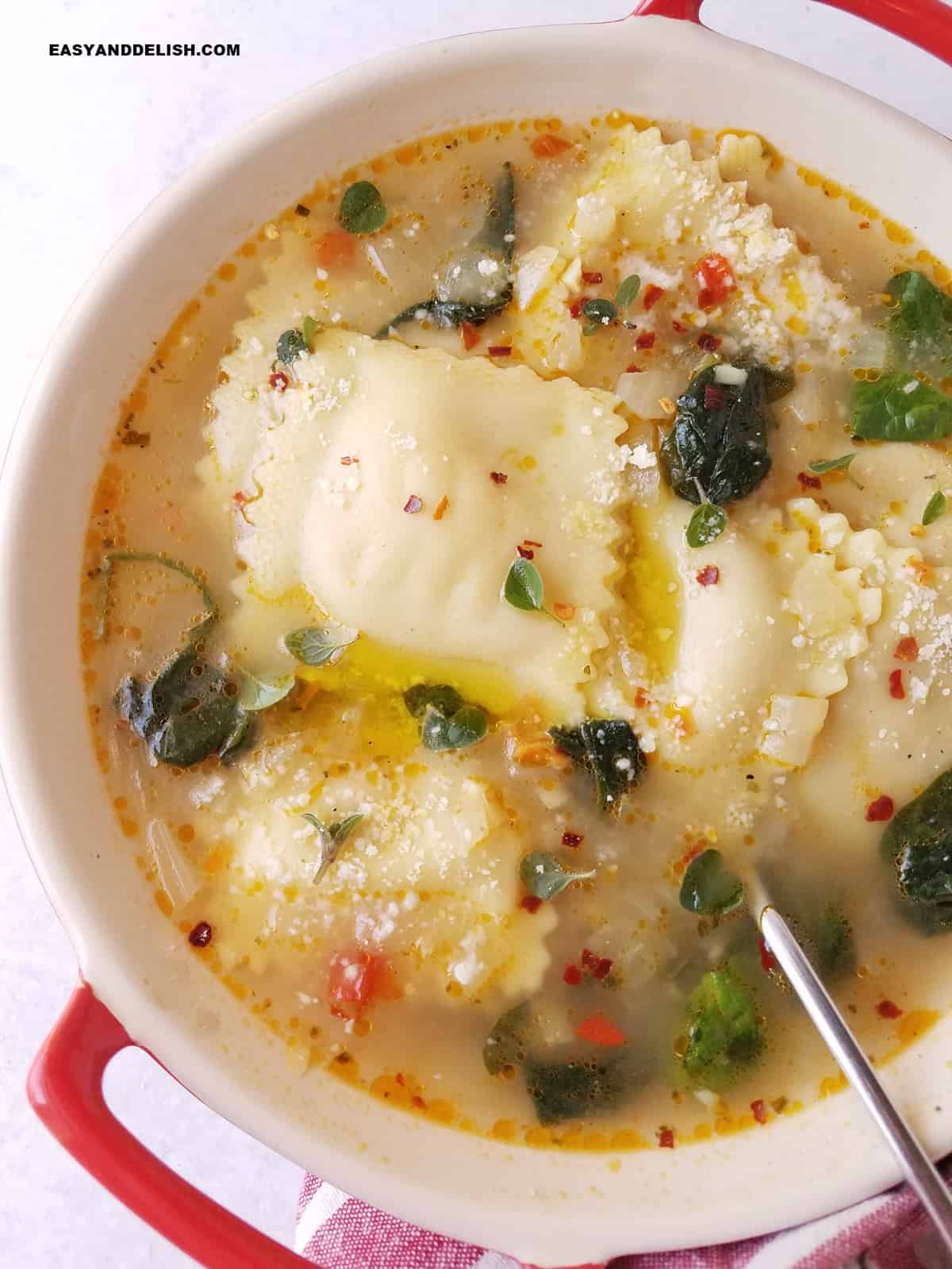 a close up of a bowl of hot meal with a spoon of the side.