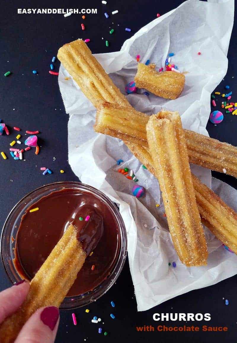 churros with chocolate sauce plus sprinkles over the table