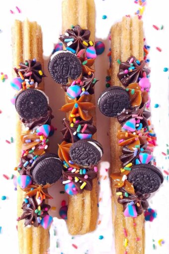 churros pipped and topped with mini Oreos over a rack