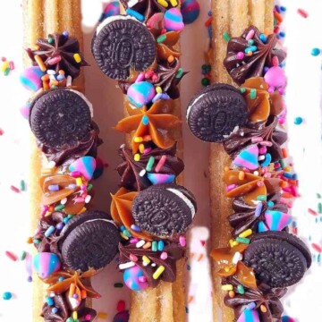 churros pipped and topped with mini Oreos over a rack