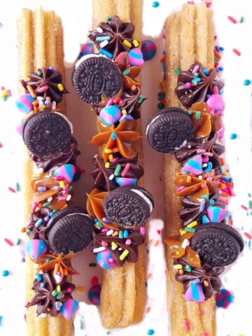 churros pipped and topped with mini Oreos over a rack