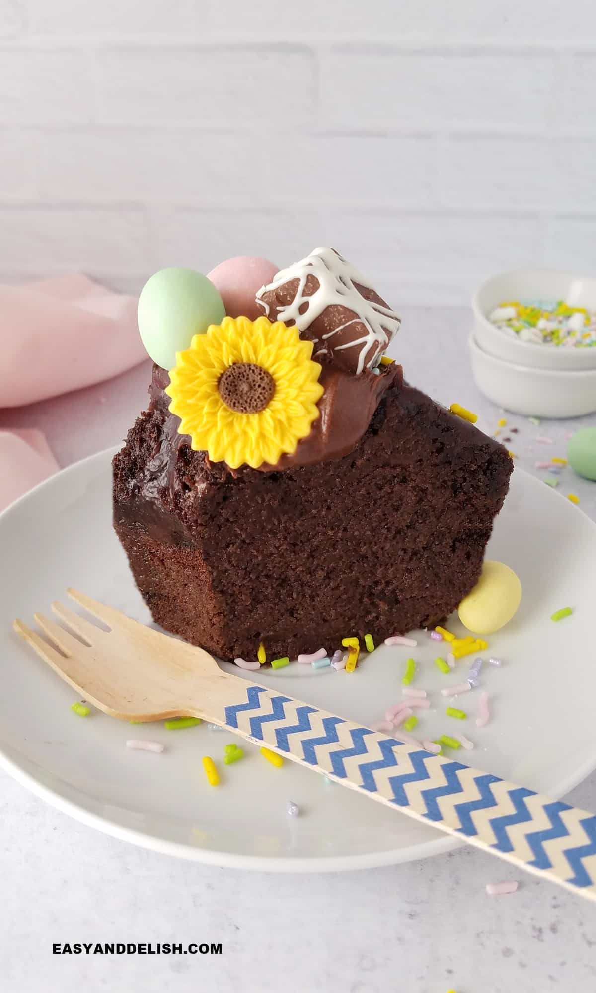 A slice of an Easter bundt cake in a  plate with a fork on teh side. 