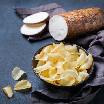 sliced cassava root and a bowl of yuca chips