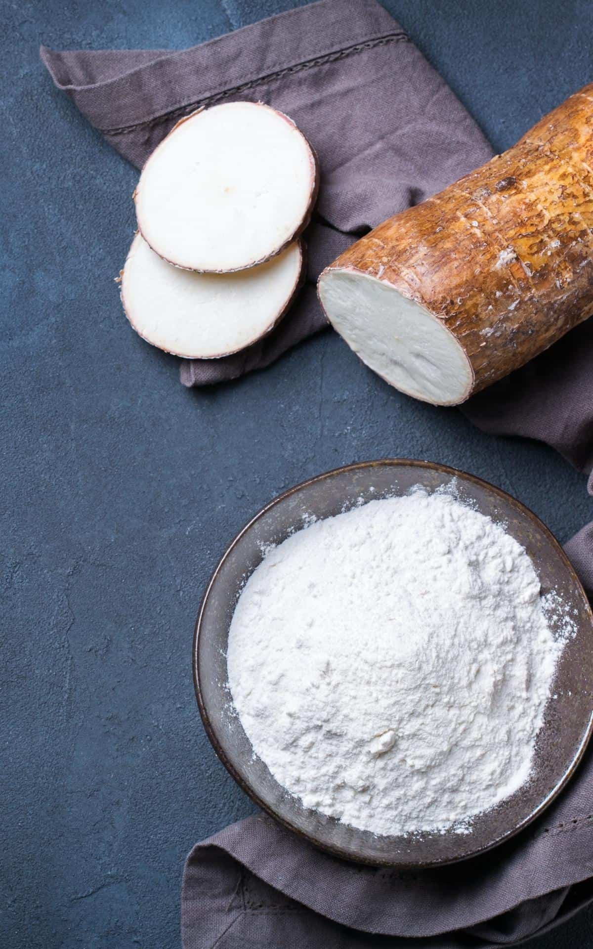 a bowl of tapioca flour and sliced yuca root