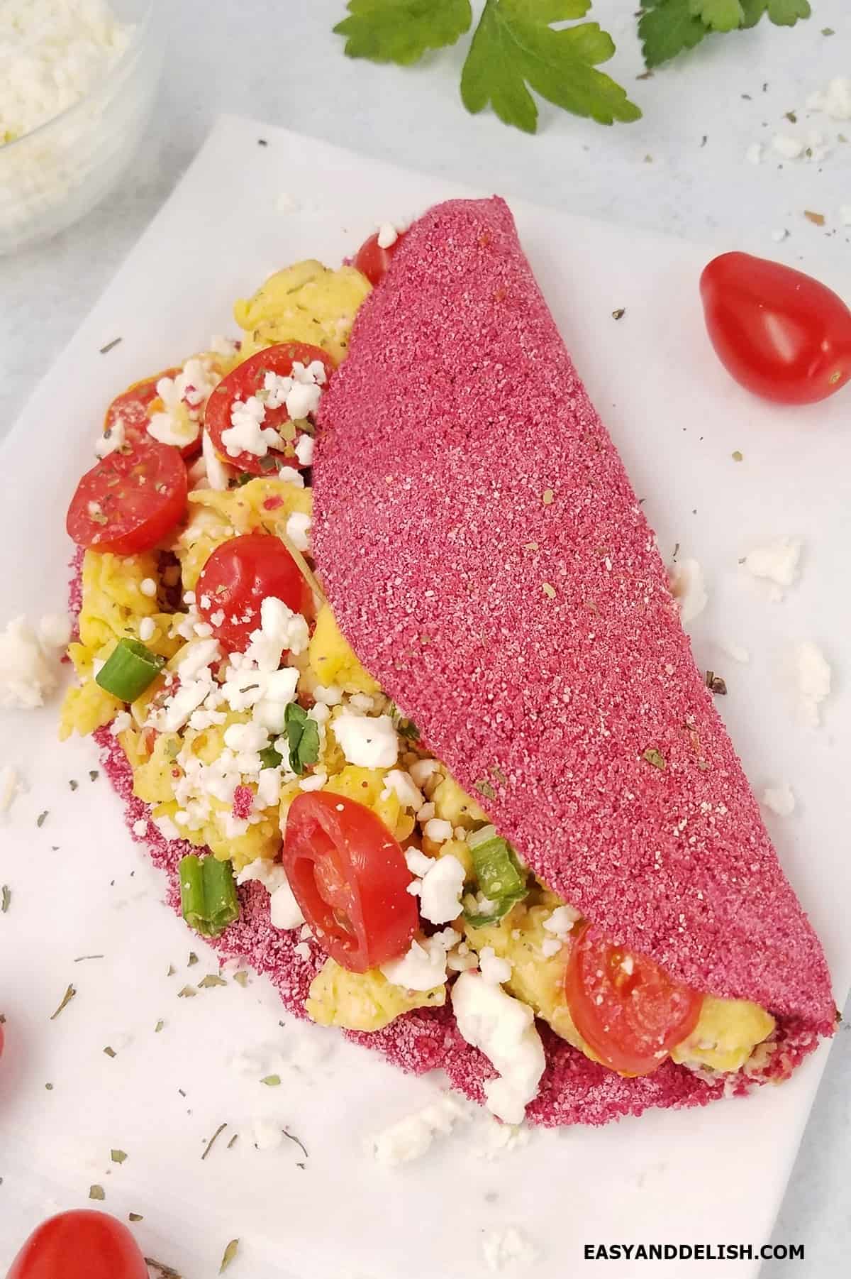 Pink tapioca crepe filled with scrambled eggs.