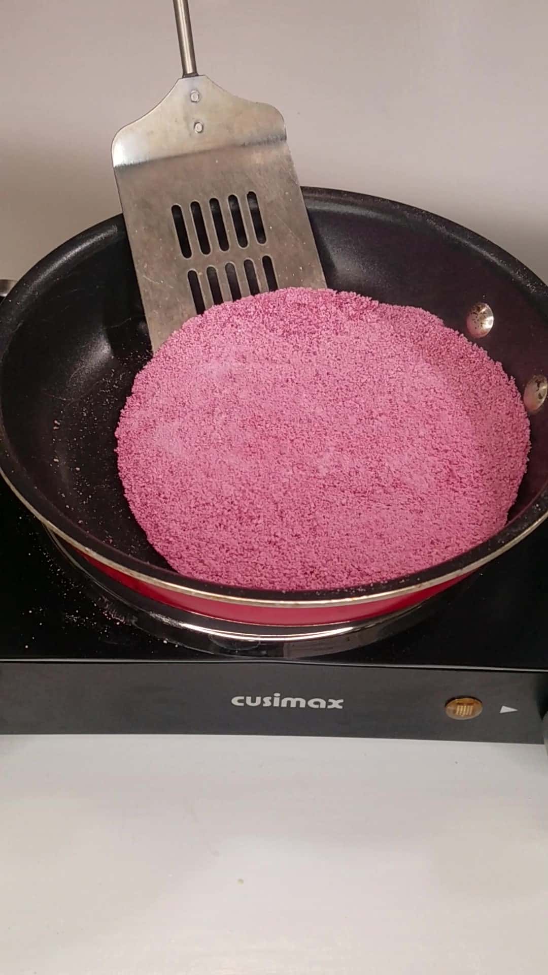 Flipping a Brazilian tapioca crepe in a skillet.