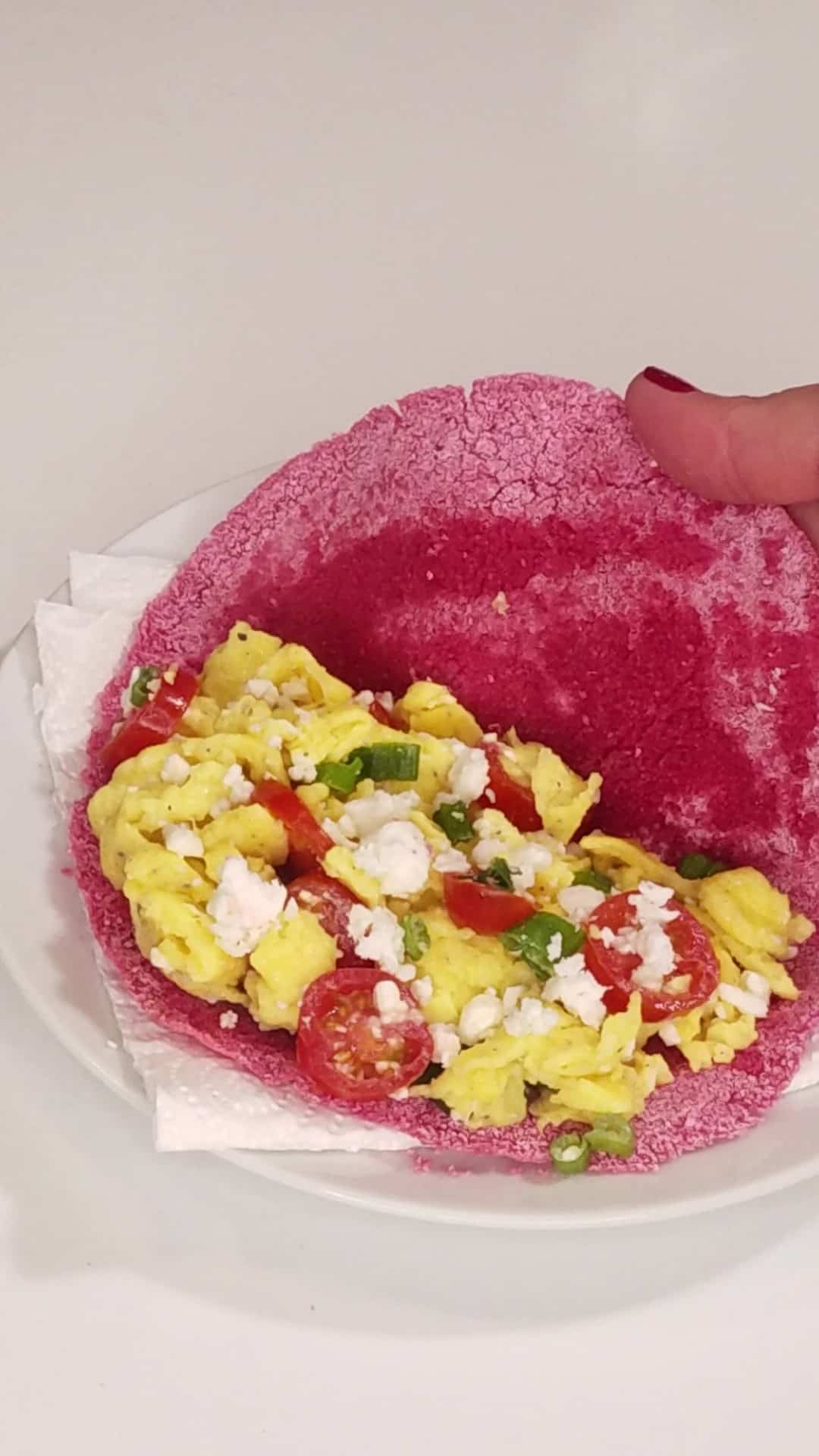 Filling a tapioca crepe with scrambled eggs.