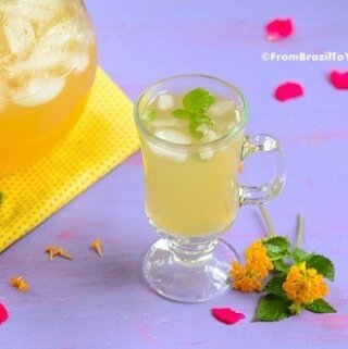 A glass of pineapple tea with mint leaves