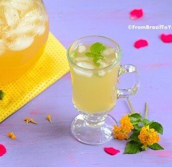 A glass of pineapple tea with mint leaves