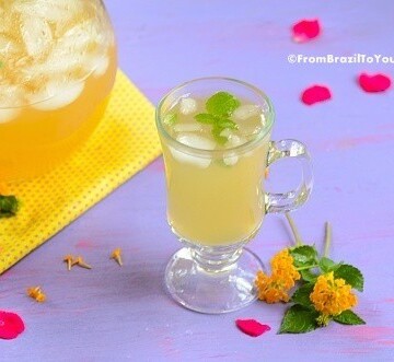 A glass of pineapple tea with mint leaves