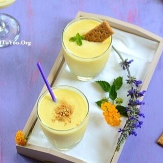 Two glasses of pina colada smoothie on a tray