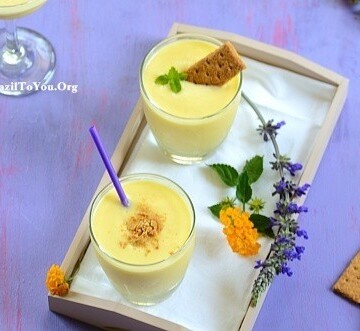 Two glasses of pina colada smoothie on a tray