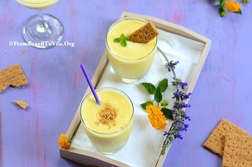 Two glasses of pina colada smoothie on a tray