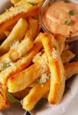 close up of yuca fries with sauce