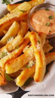 close up of yuca fries with sauce