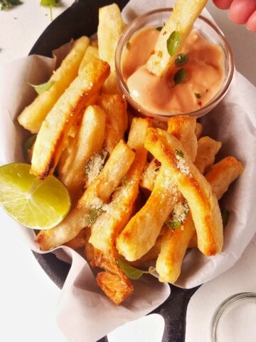 yuca fries dipped in sauce