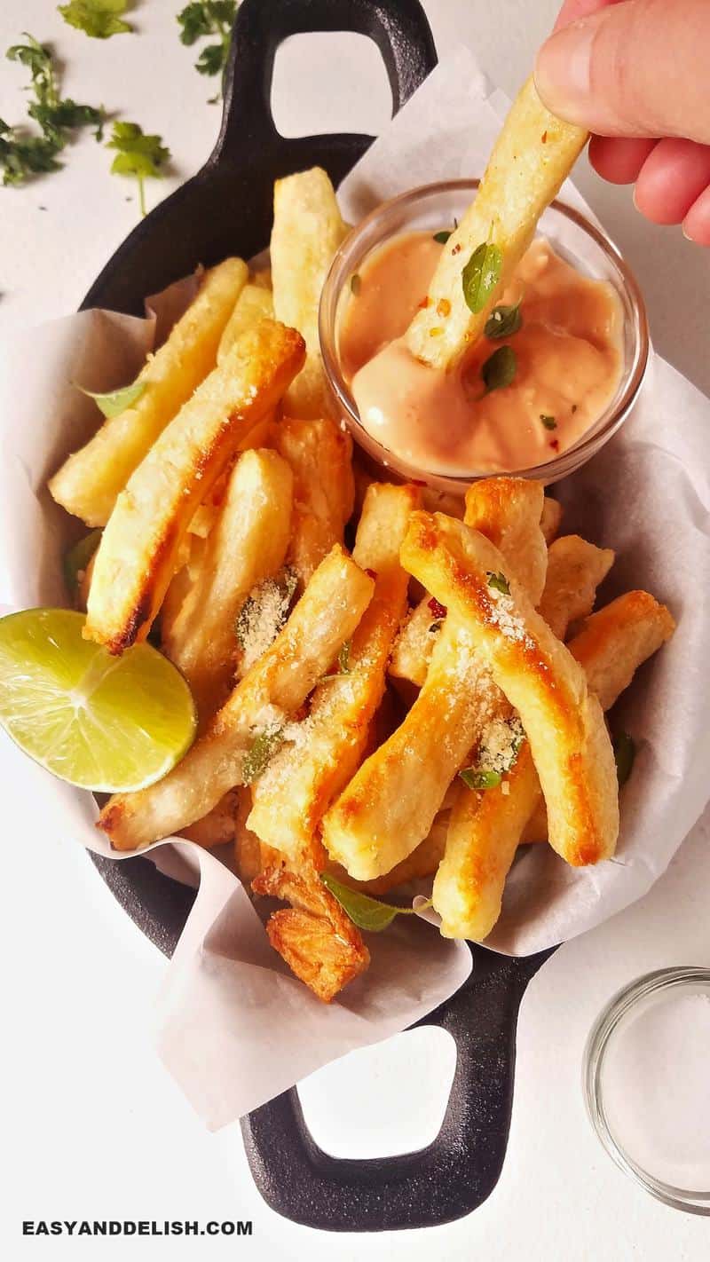 yuca fries dipped in sauce