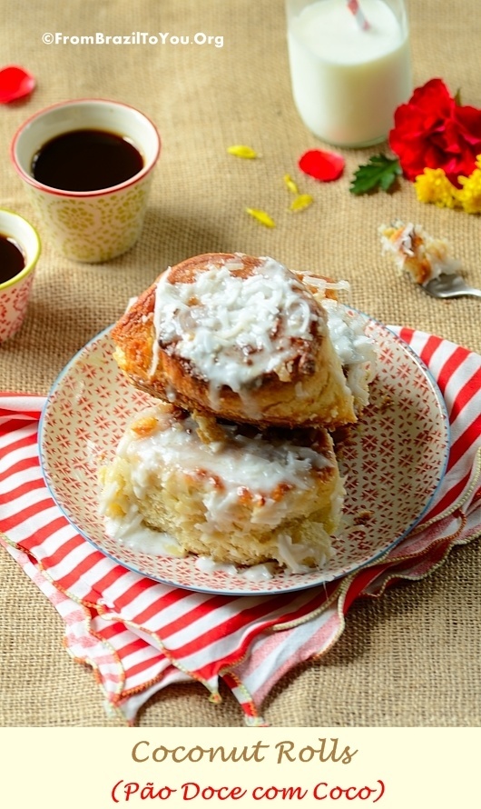 Sweet rolls topped with with coconut icing on a plate next to little cups of espresso coffee