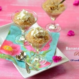 Three glasses filled with banana coconut pudding and topped with whipped cream