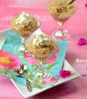 Three glasses filled with banana coconut pudding and topped with whipped cream