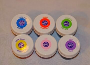 Caps from Wilton blue, orange, green, yellow, pink, and violet food coloring gels