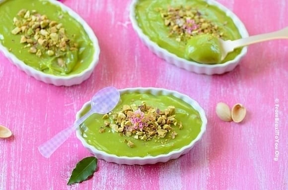 Three ramekins of green creme de abacate, mousse de abacate, or avocado mousse on a board