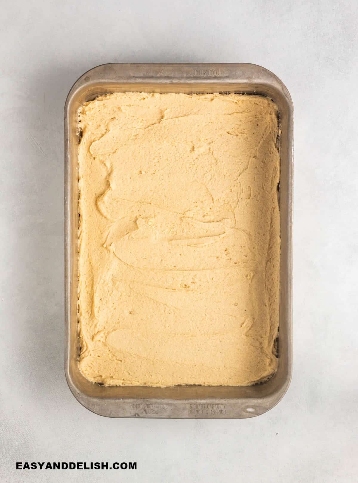 batter spread onto the bottom of a baking pan.