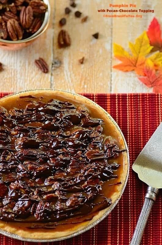 Best Pumpkin Pie with Pecan-Chocolate Topping with a slicer and nuts 