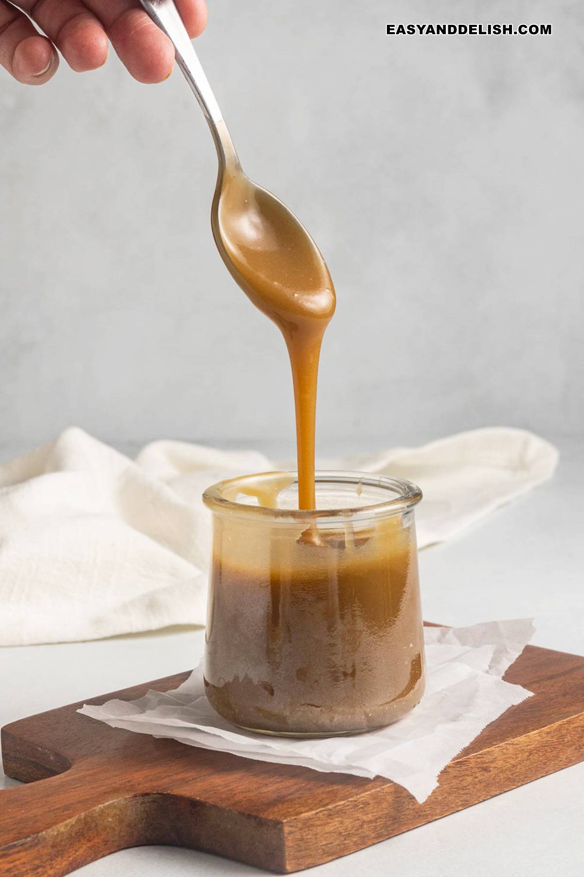 thickened caramel in a jar spooned over.