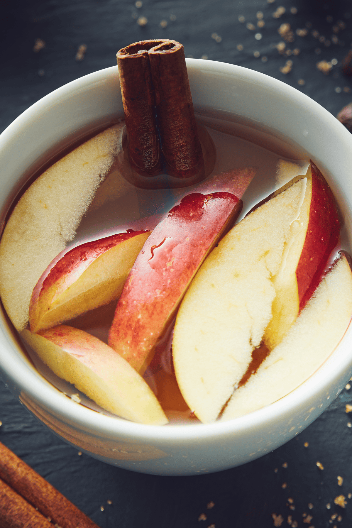 apple juice and spices simmering on a pot.