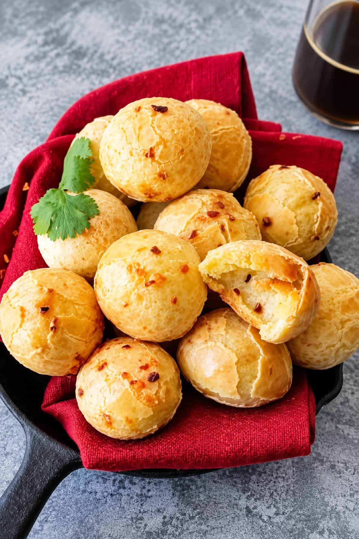 Brazilian cheese bread with golden crispy crusts and soft cheesy centers served in a skillet.