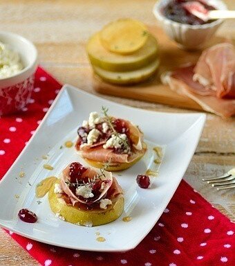 A plate with bruleed pears and garnishes on the sides