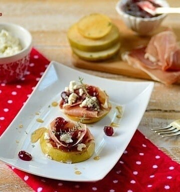 A plate with bruleed pears and garnishes on the sides