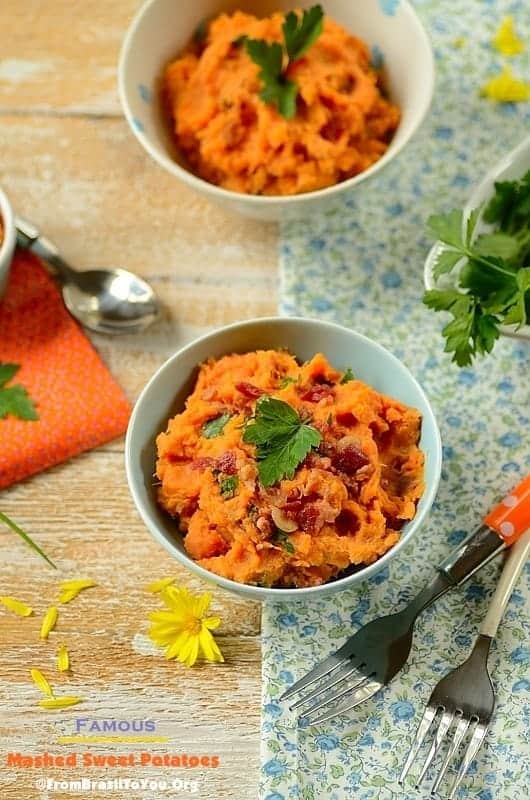 2 bowls of mashed sweet potatoes with silverware on the side