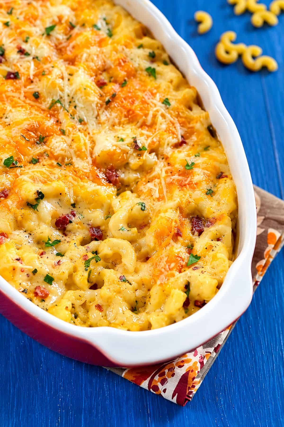 Creamy mac and cheese carbonara with melted cheese, bacon, and fresh herbs.