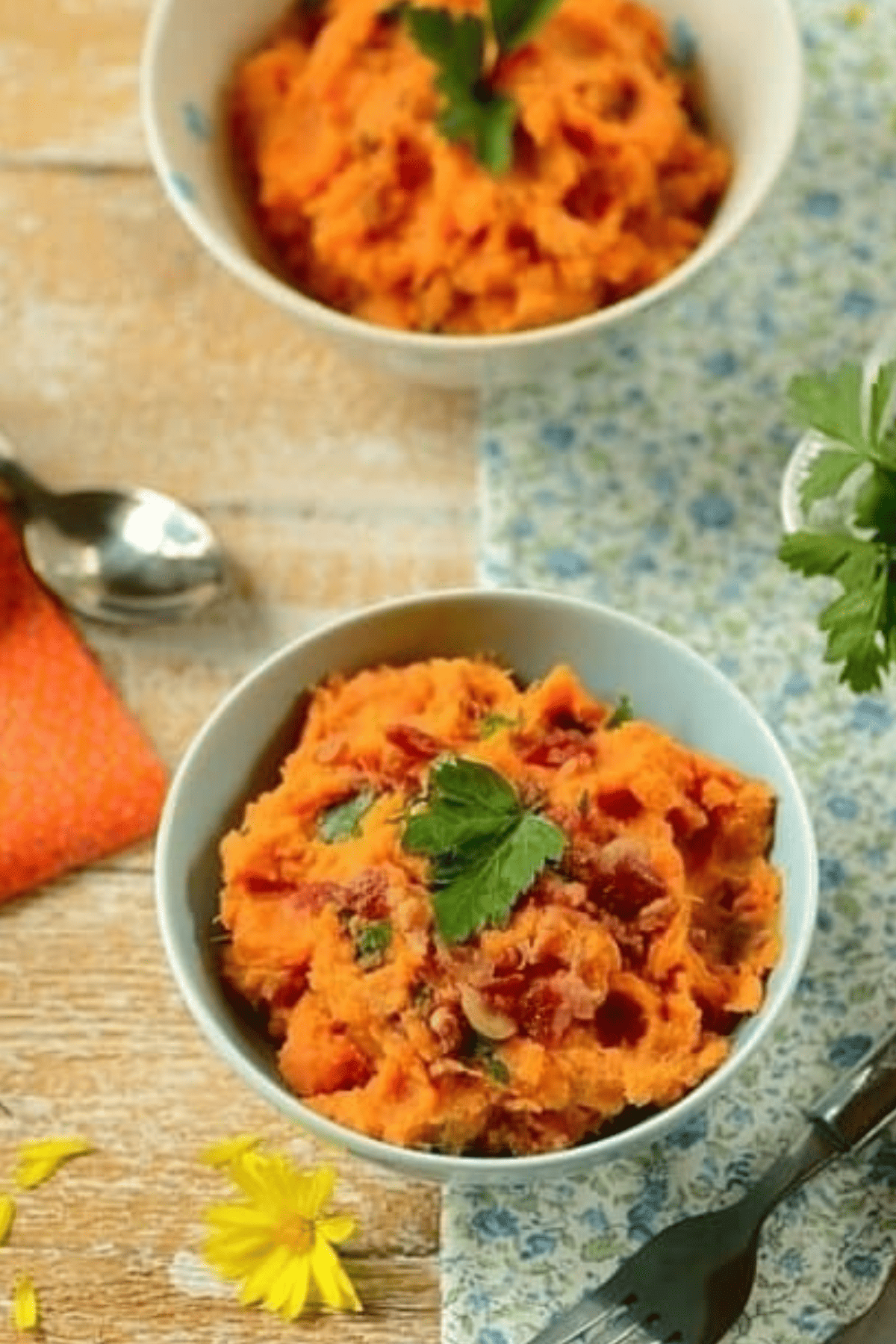 Savory mashed sweet potatoes with coconut milk, bacon, and cilantro in bowls.